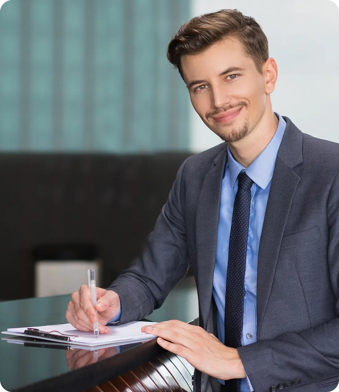 Professional insurance advisor seated at a desk reviewing documents, representing coverage guidance for rentals and home-based businesses