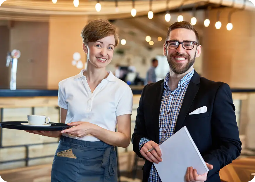Restaurant manager and waitress illustrating the comprehensive coverage included in hospitality insurance.
